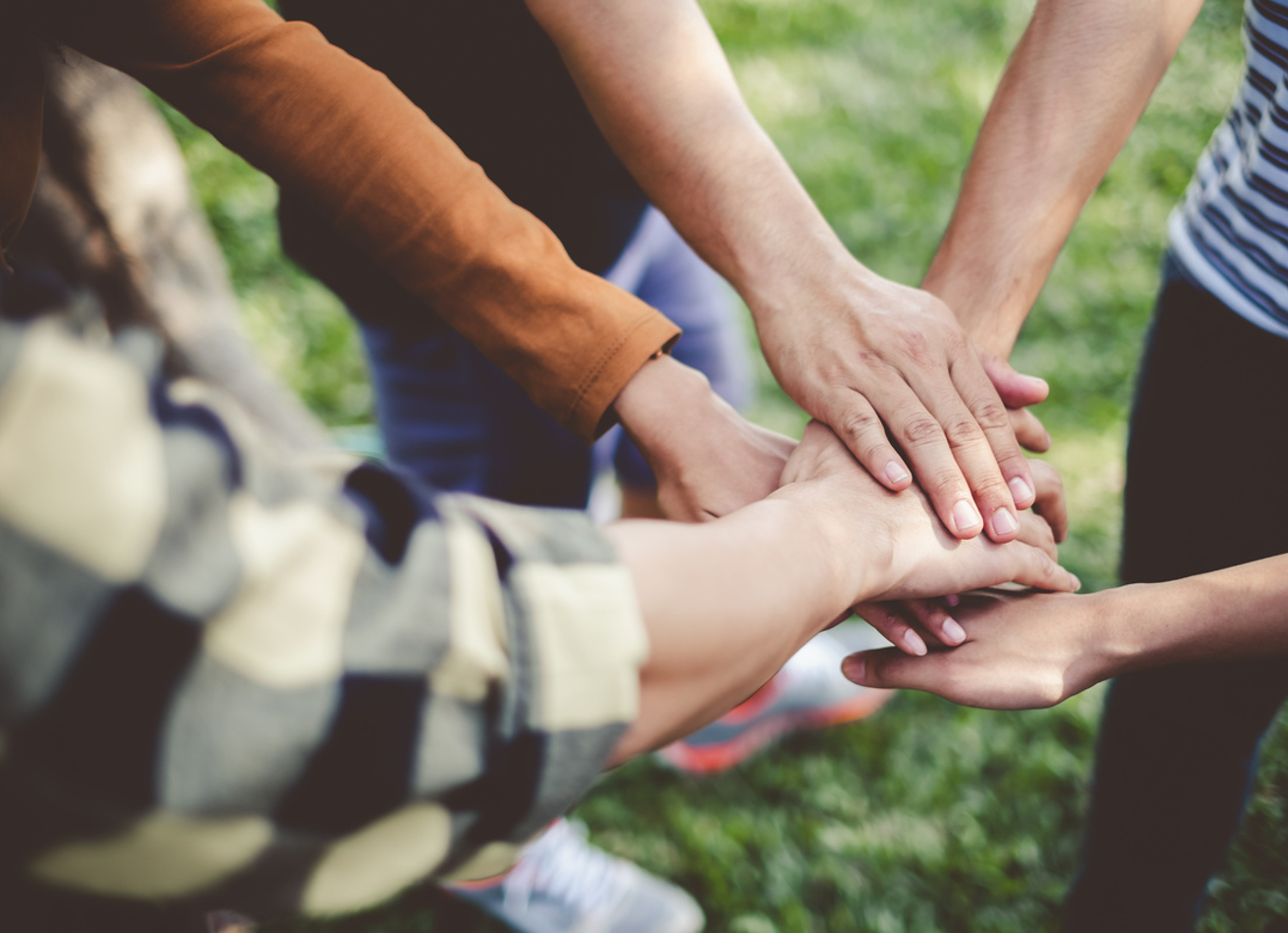 volunteers putting hands together